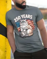 250 Years Patriotic Cat American Flag Graphic T Shirt - model wearing grey tee, leaning on column