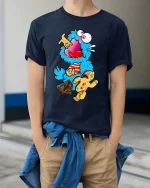 Crazy Blue Monster Cookie Candy Funny Graphic T Shirt Cartoon - model wearing navy tee with hands in pockets