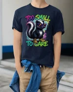 Too Small To Care Funny Skunk Cool Graphic T Shirt Attitude - model wearing navy tee with hands in pockets