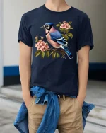 Blue Jay Bird Blossom Graphic T Shirt Elegant Nature Art Tee - model wearing navy tee with hands in pockets
