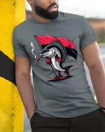 Funny Rebel Fish With Flag Graphic T Shirt Cool Cartoon Tee - model wearing grey tee, leaning on column