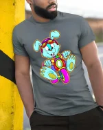 Cute Bunny Riding Bike Cartoon T Shirt Funny Colorful Graphic - model wearing grey tee, leaning on column