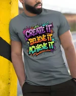Create Believe Achieve Motivational Color Splash Graphic T-Shirt - model wearing grey tee, leaning on column