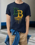 Green Gold Drip Letters Football Fan Style Graphic Tshirt - model wearing navy tee with hands in pockets