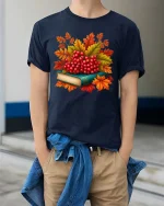 Autumn Berries Book Stack Graphic T-Shirt Cozy Fall Tee - model wearing navy tee with hands in pockets