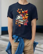 Cozy Autumn Books Coffee Graphic T-Shirt Fall Reading Tee - model wearing navy tee with hands in pockets