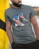 USA Flag Sneakers Patriotic Style Graphic T Shirt - model wearing grey tee, leaning on column