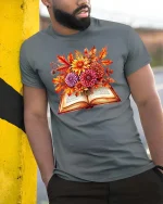 Autumn Book Floral Graphic T Shirt Cozy Fall Reader Tee - model wearing grey tee, leaning on column