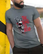 The King Is Dead Skull Crown Graphic T Shirt Dark Gothic - model wearing grey tee, leaning on column
