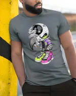 Street Raven Skull Sneaker Style Urban Graphic tshirt - model wearing grey tee, leaning on column