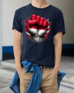 Powerful Red White Fist T Shirt Bold Strength Statement Graphic - model wearing navy tee with hands in pockets